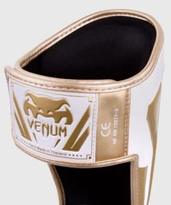Venum ELITE Shin Guards - White/gold 5 Venum ELITE Shin Guards - White/gold -Boxing Equipment Store e60a097ecd90455a1197448726fe930595673983 IMG 0320 2 copie